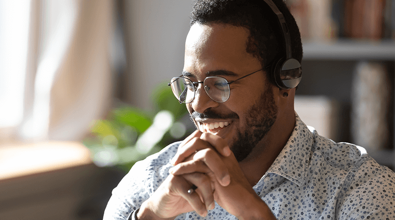 man with headphones smiling 