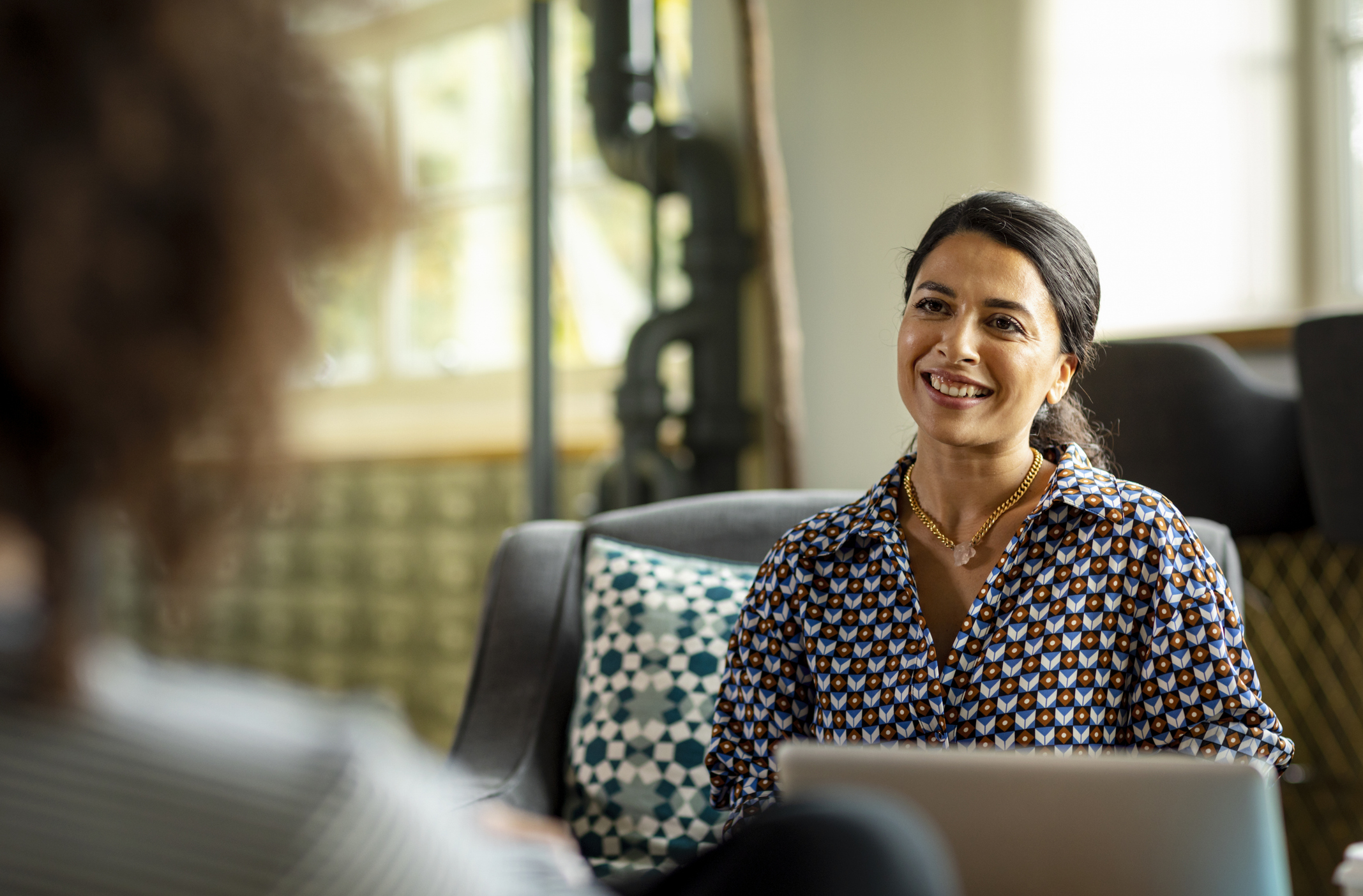 two women an in interview smiling